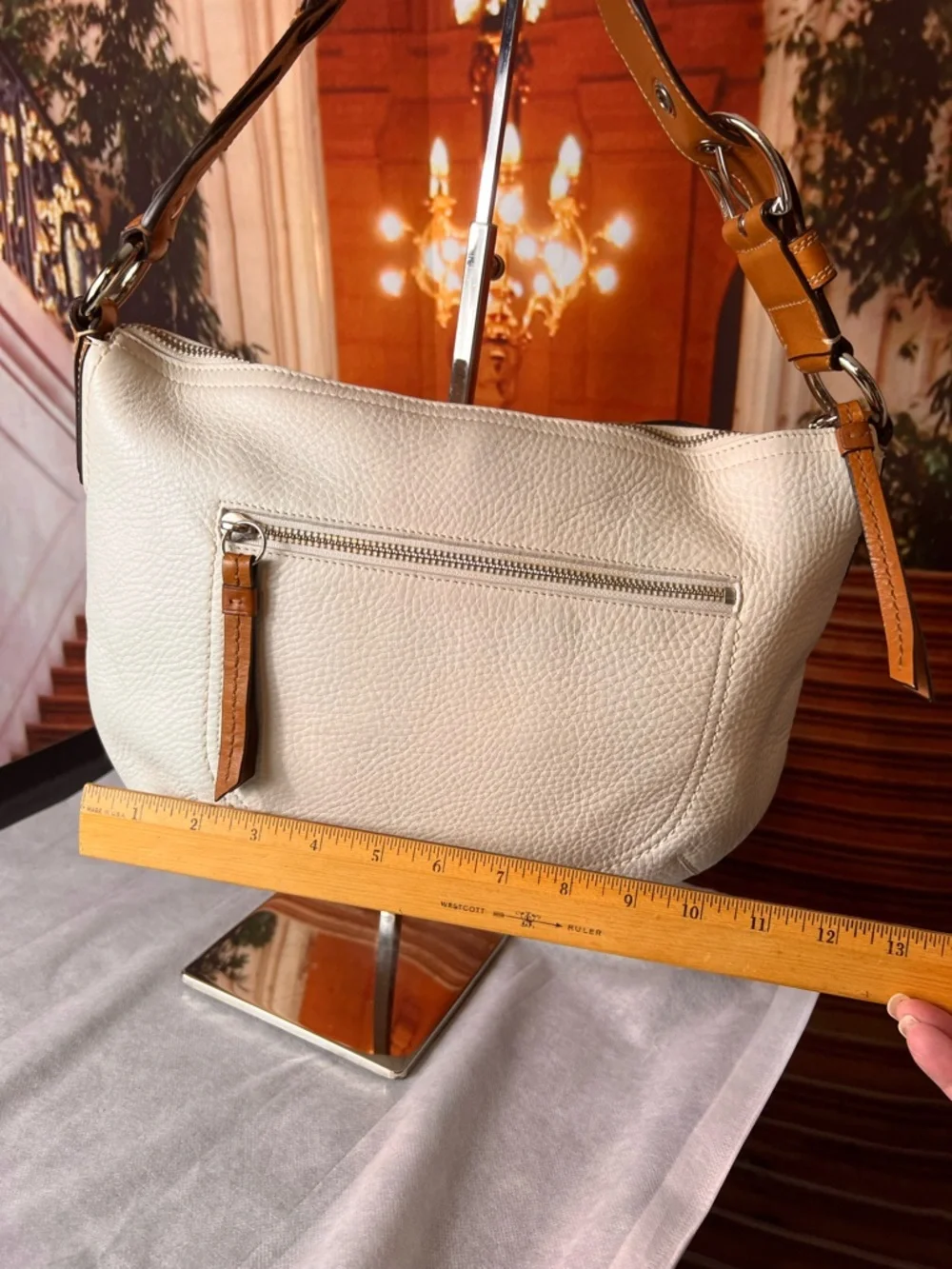 Coach Soho White Pebbled Leather Hobo bag features a distinctive braided handle